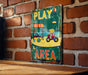 a sign on a brick wall that says play area