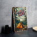 a sign that says camp life next to a cup of coffee