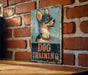 a dog training sign on a brick wall
