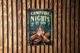 a campfire nights sign hanging on a wooden wall