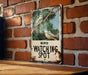 a bird watching spot sign on a brick wall