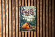 a camp life sign hanging on a wooden wall
