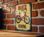 a bike rental sign on a brick wall