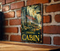 a picture of a fishing cabin hanging on a brick wall