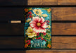 a book with flowers painted on it sitting on a bench