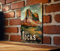 a picture of a red rocks sign on a brick wall