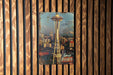 a picture of a space needle on a wooden wall