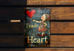 a sign on a wooden bench that says teach heart
