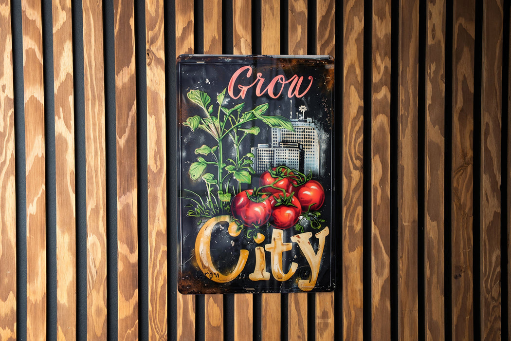 a sign that says grow city with tomatoes on it