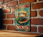 a soup sign on a brick wall next to a wooden table