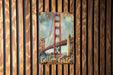 a picture of a golden gate bridge on a wooden wall
