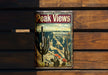 a can of peak views sits on a wooden bench
