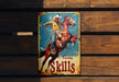 a metal sign with a cowboy riding a horse