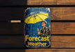 a tin sign with a man holding a yellow umbrella