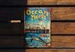 a sign that says ocean meets on a wooden wall