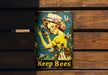 a tin can with a picture of a woman holding bees
