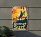 a sign on the side of a building that says sunset surf