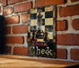 a picture of a chess board on a brick wall