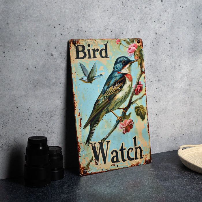 a bird watch sign sitting on top of a table