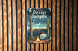 a sign on a wooden wall that says desert campfire