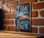 a fish on sign mounted on a brick wall