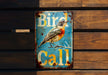 a bird is sitting on top of a sign