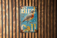 a bird is sitting on a sign on a wall