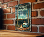 a sign on a brick wall that says desert campfire