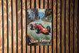 a poster of a racing car on a wooden wall