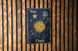 a wooden wall with a sign that says star chart on it
