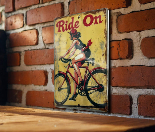 a picture of a woman riding a bike on a brick wall