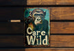 a sign on a wooden wall that says care wild