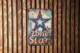 a lone star sign on a wooden wall