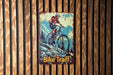 a poster of a man riding a bike on a wooden wall