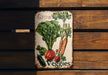 a sign that says grow veggies on it