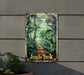 a jungle poster hanging on a wall next to a potted plant