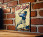 a metal sign with a picture of a baseball player holding a bat