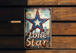a lone star sign on a wooden wall