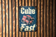a sign on a wooden wall that says cube fast