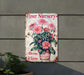a flower nursery sign hanging on a wall
