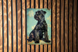 a black dog sitting on top of a wooden wall