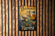 a beehive sign hanging on a wooden wall