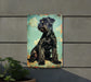 a black dog sitting on top of a metal sign