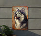 a metal sign with a picture of a dog on it