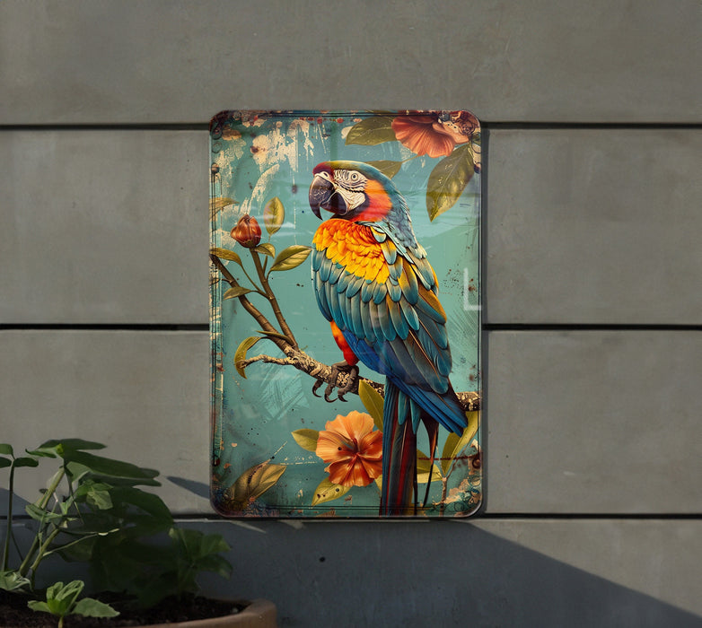 a colorful parrot sitting on top of a metal box