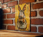 a picture of a rabbit on a brick wall