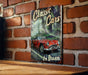 a picture of a classic car on a brick wall