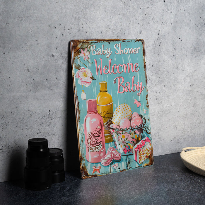 a baby shower welcome baby sign next to a plate