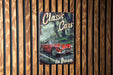 a poster of a classic car on a wooden wall