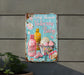 a baby shower sign hanging on the side of a building
